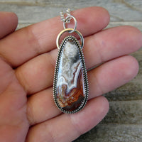 Mexican Crazy Lace and Sterling Silver Pendant on hand