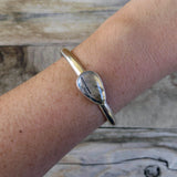 Tourmalinated quartz and sterling silver cuff bracelet on arm