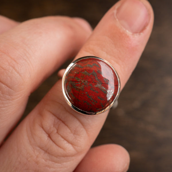 Red australian snakeskin and sterling silver ring on finger